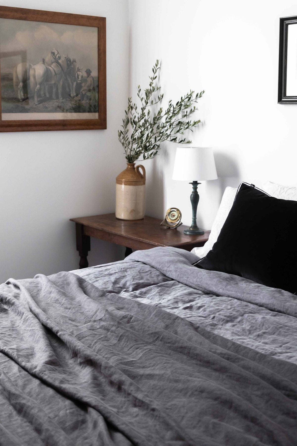 Main bedroom with earthy linen and antique side table