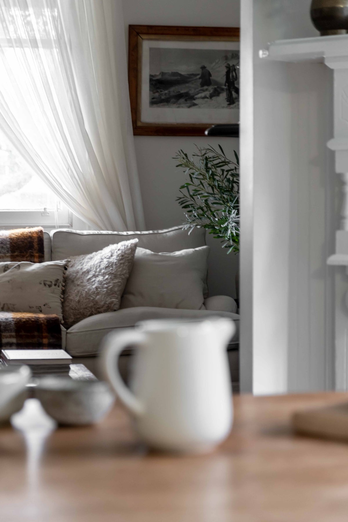 Milk pouring jar with lounge room in the distance